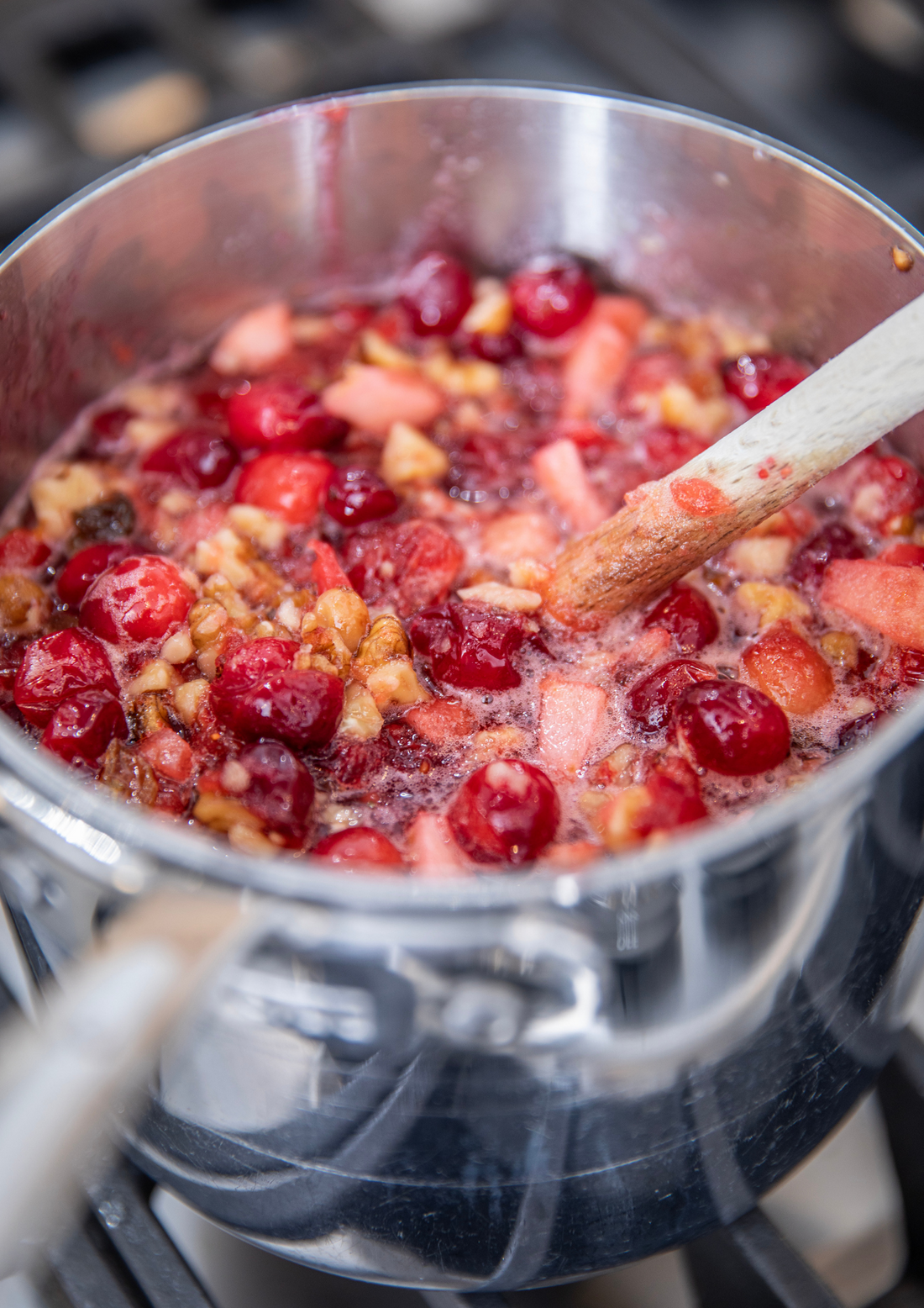 Ina Garten's Cranberry Fruit Conserve in a jar with fresh cranberries
