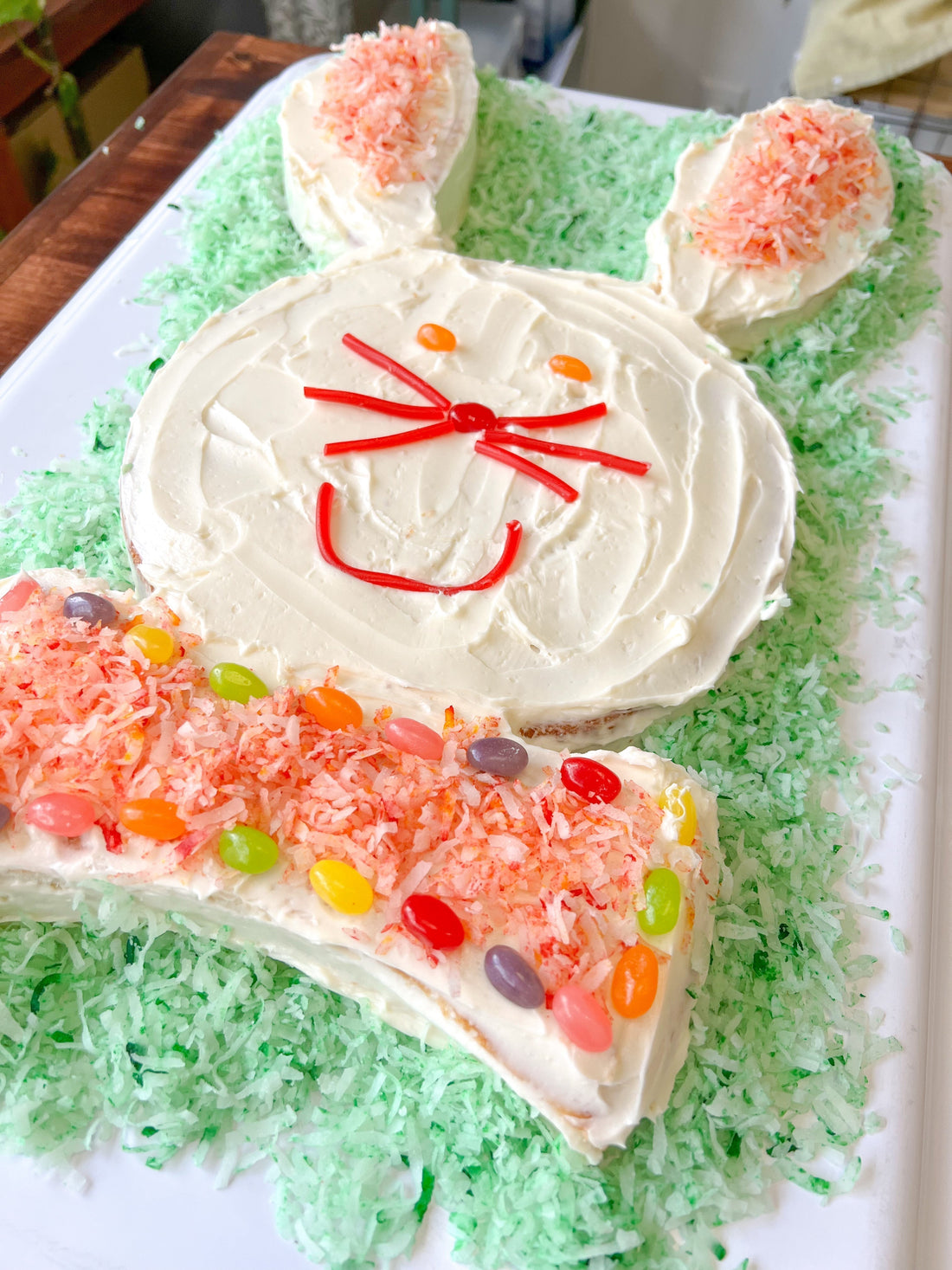 Family Easter bunny cake decorated through four decades of tradition on a cake stand