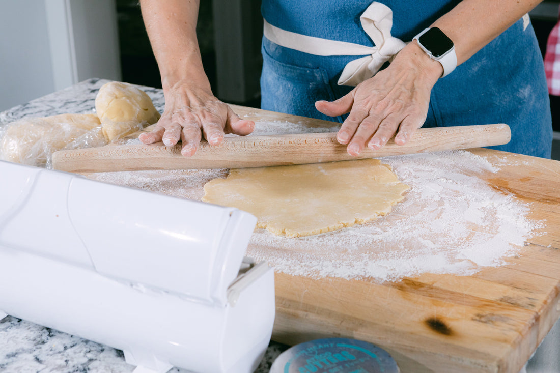 Three of Ina Garten's most-loved kitchen tools including a Dutch oven, sheet pan, and whisk