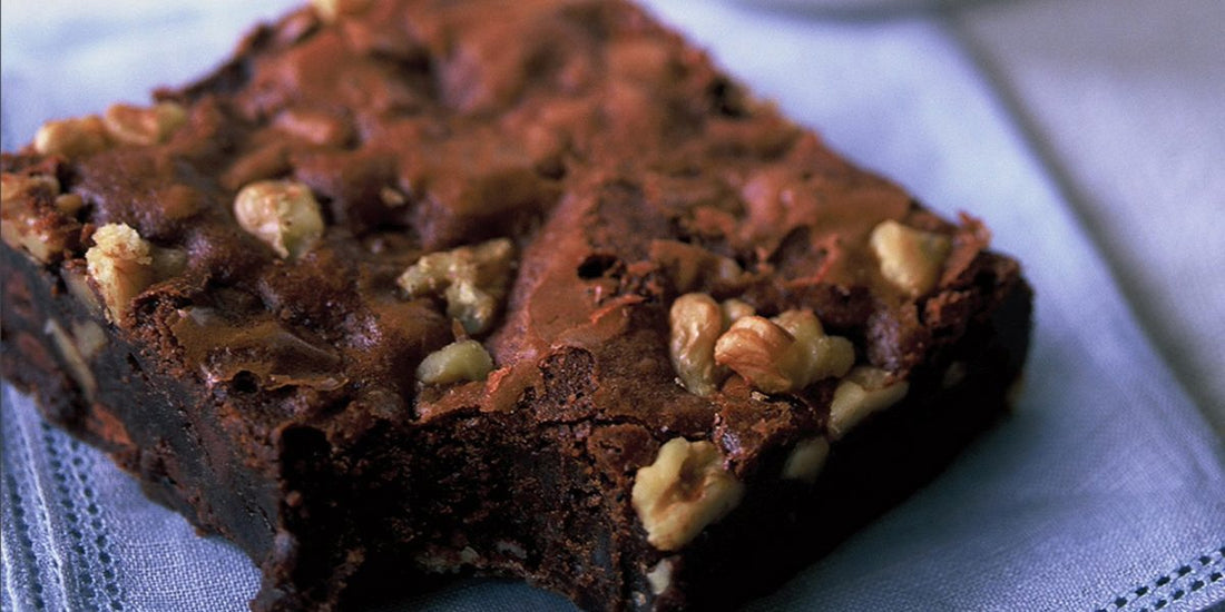 Ina Garten's Outrageous Brownies — two rich fudgy chocolate walnut brownies on a blue linen napkin