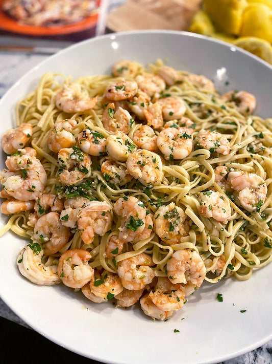 Ina Garten's Linguine with Shrimp Scampi in a large white bowl garnished with fresh parsley