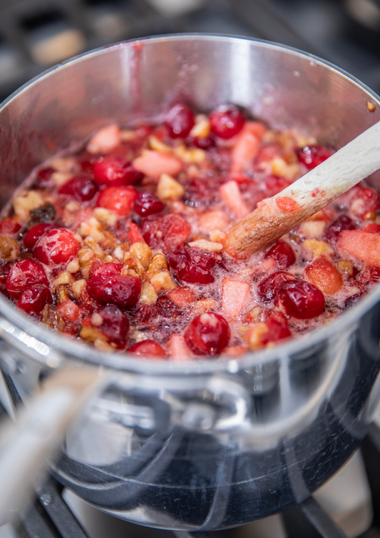 Ina Garten's Cranberry Fruit Conserve in a jar with fresh cranberries