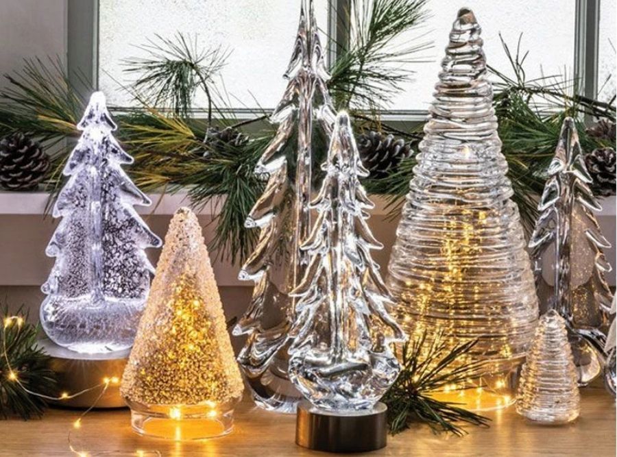 Simon Pearce hand-blown glass trees styled in a home holiday display with seasonal greenery