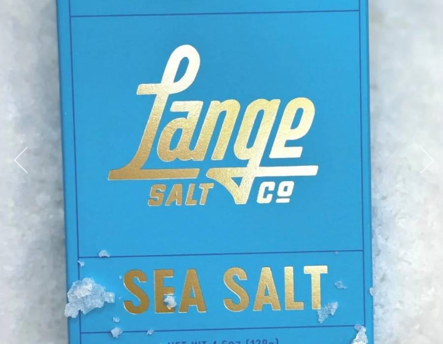 Lange Salt artisan sea salt in a bowl with a wooden spoon on a kitchen surface