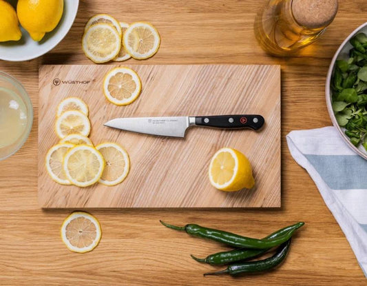 Wüsthof professional chef's knives on a cutting board in a modern kitchen