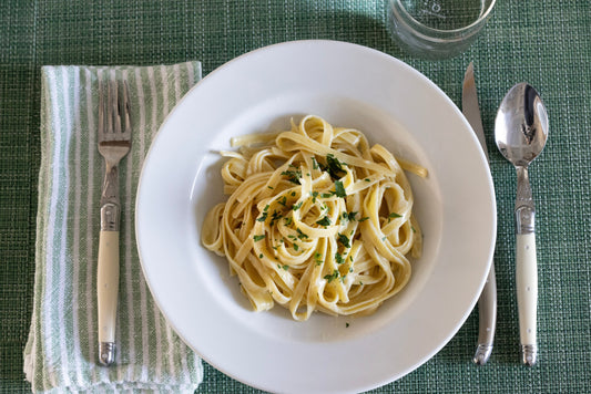 Homemade Fettuccine Alfredo pasta with creamy parmesan sauce in a bowl