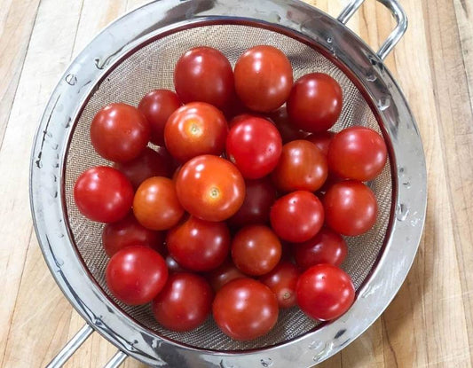 Sharp chef's knife slicing a ripe tomato, showing why the right knife matters