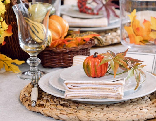 Beautiful fall table setting with autumn colors, candles, and seasonal harvest decor