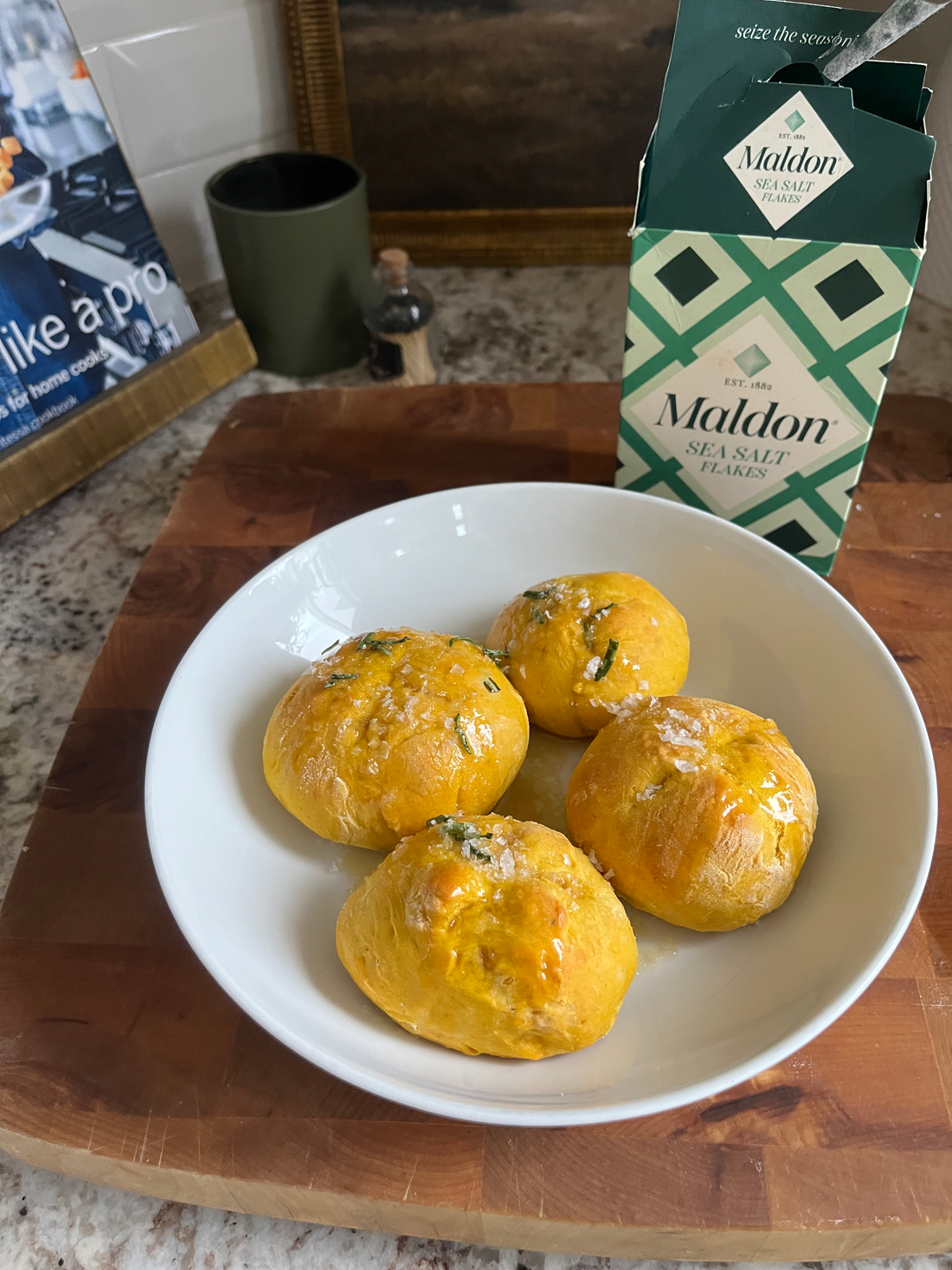 Homemade Pumpkin Rolls with Rosemary and Sea Salt on a baking sheet