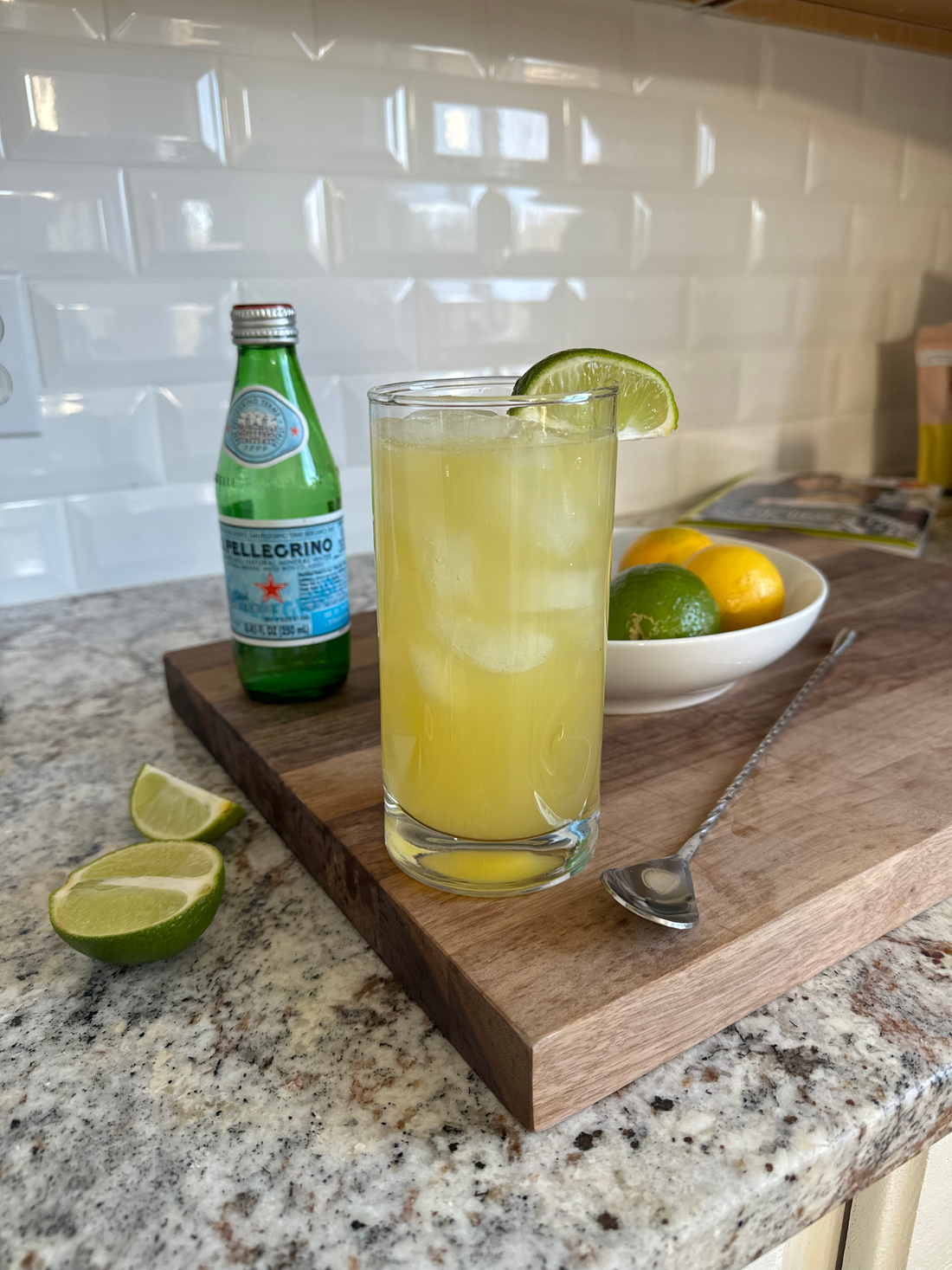 Pineapple Lime Mocktail in a tall glass with fresh pineapple and lime garnish