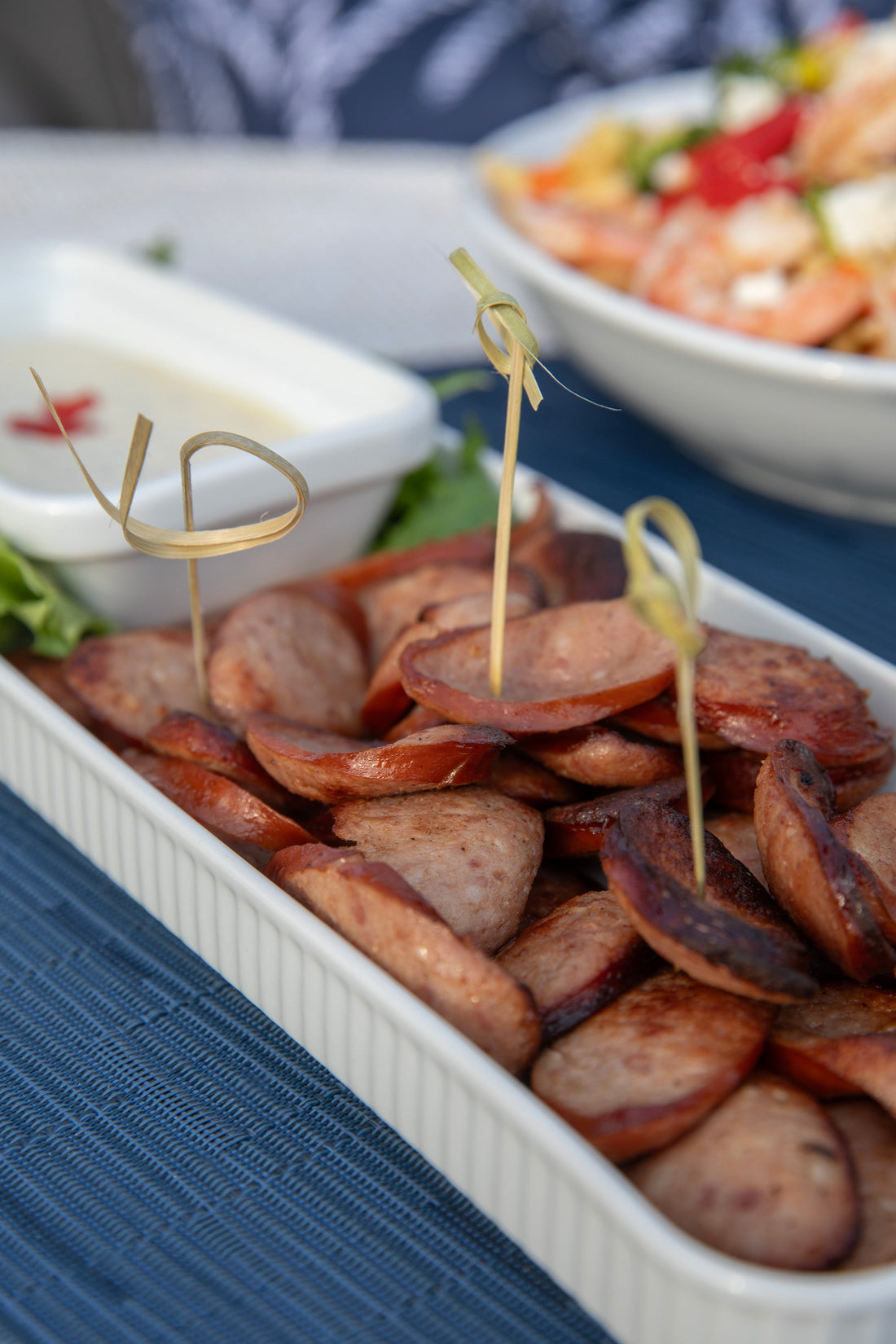 Ina Garten's Kielbasa with Mustard Dip on a serving board with toothpicks