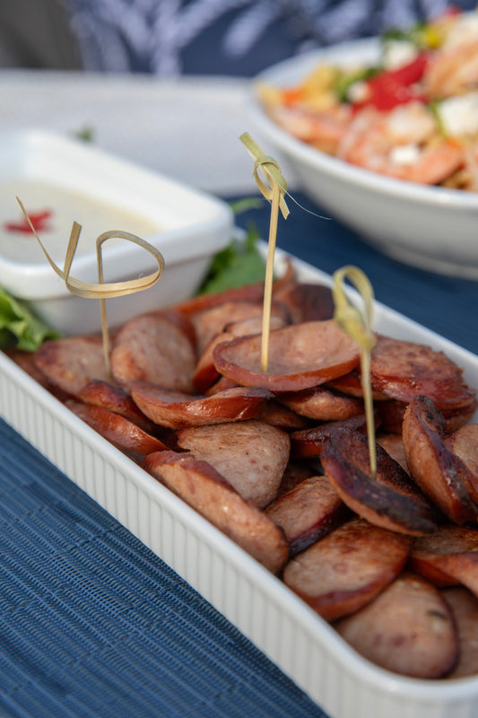 Ina Garten's Kielbasa with Mustard Dip on a serving board with toothpicks