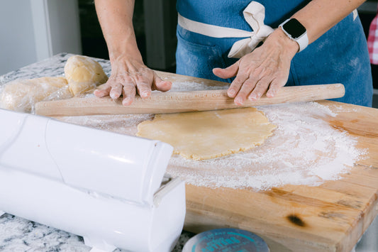 Three of Ina Garten's most-loved kitchen tools including a Dutch oven, sheet pan, and whisk