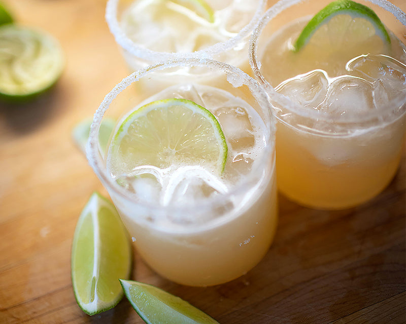 Ina Garten's updated classic daiquiri cocktails with lime slices and salted rims in three glasses