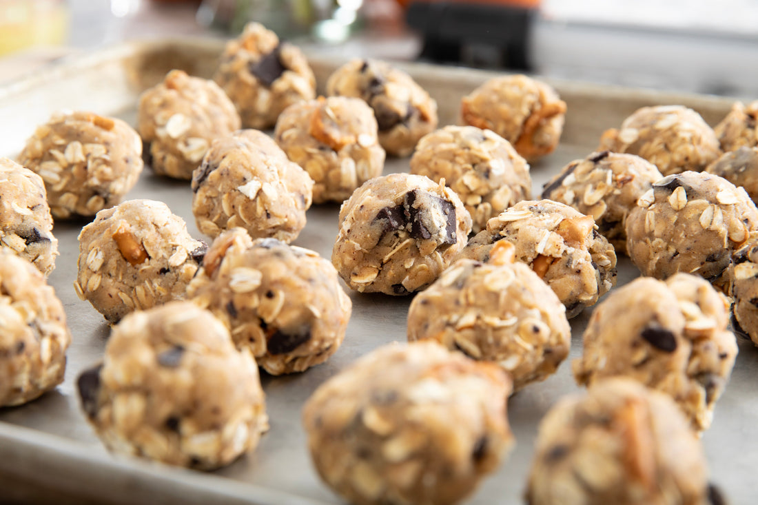 Grossy Pelosi's Oatmeal Cookie Hugs with chocolate kiss centers on a baking sheet