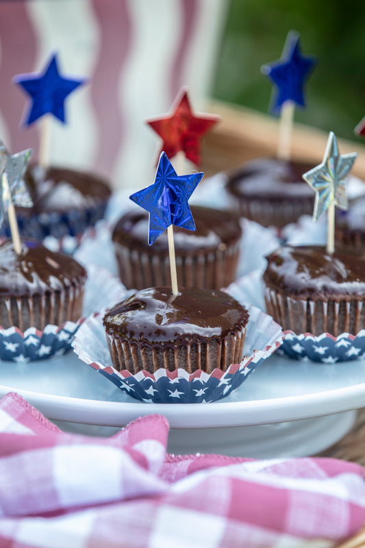 Ina Garten's Chocolate Ganache Cupcakes with patriotic star picks in red, white, and blue cupcake liners