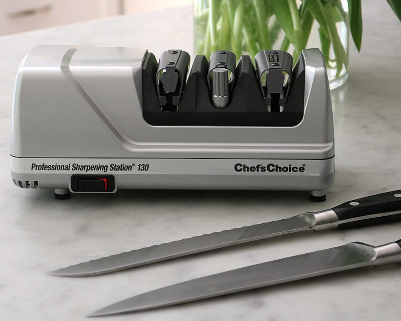 Chef's Choice Professional Sharpening Station 130 electric knife sharpener with two kitchen knives on marble