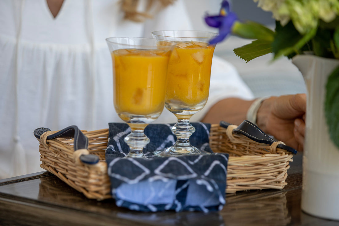 Ina Garten's Mango Daiquiri cocktails in glasses garnished with fresh lime and mango