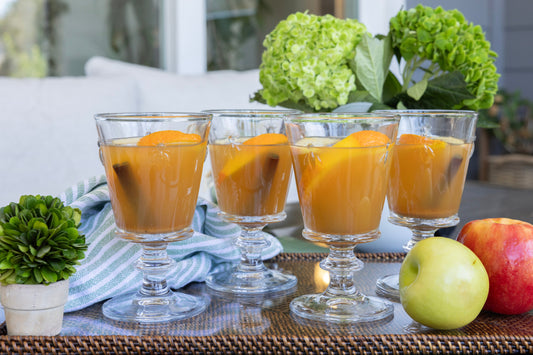 Ina Garten's Hot Spiced Apple Cider with cinnamon sticks and apple slices in a mug