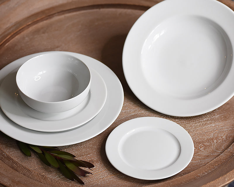 Pillivuyt White Dinnerware Collection including a dinner plate, salad plate, dessert plate, cereal bowl, and soup bowl.