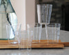 6 farmhouse borosilicate glasses stacked on wooden cutting board