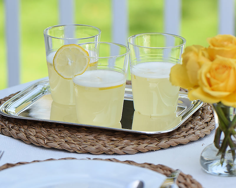 3 farmhouse glasses filled with lemonade served on silver tray