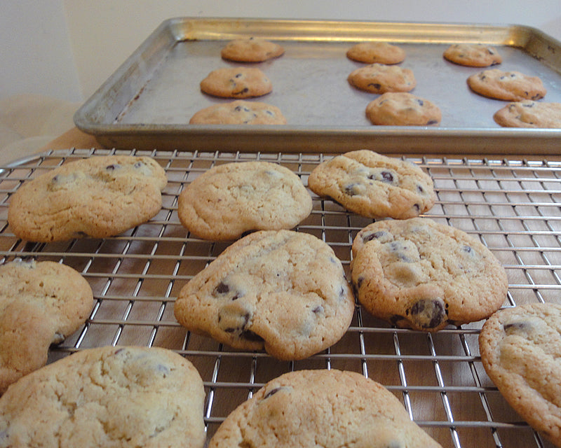 Professional Half Sheet Pan and Cross Wire Cooling Rack used by Ina Garten with cookies baking and cooling on top.