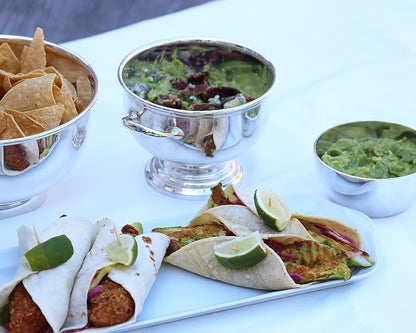 Simple take-out tacos served on the Narrow Platter surrounded by Hotel Silver Bowls filled with tortilla chops and guacamole. 
