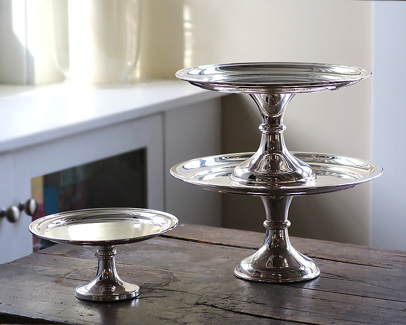12, 10, and 8 inch vintage silver plated HÔTEL Silver Cake Stands on wood table