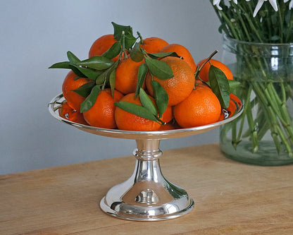 Vintage HÔTEL Silver Cake Stand displaying oranges
