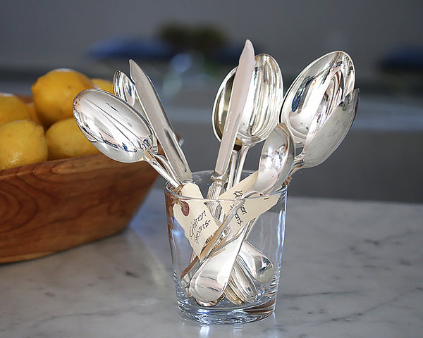 HÔTEL Vintage English Kitchen Spoons in a glass mixed with HÔTEL Silver Spreaders and Chowder Spoons