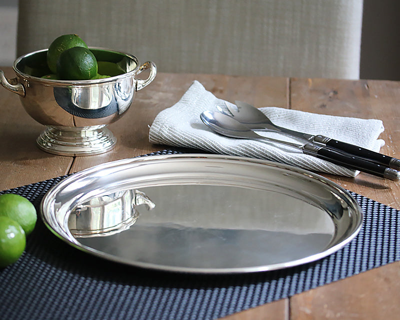 12-inch HOTEL Silver Round sitting on a black placemat.