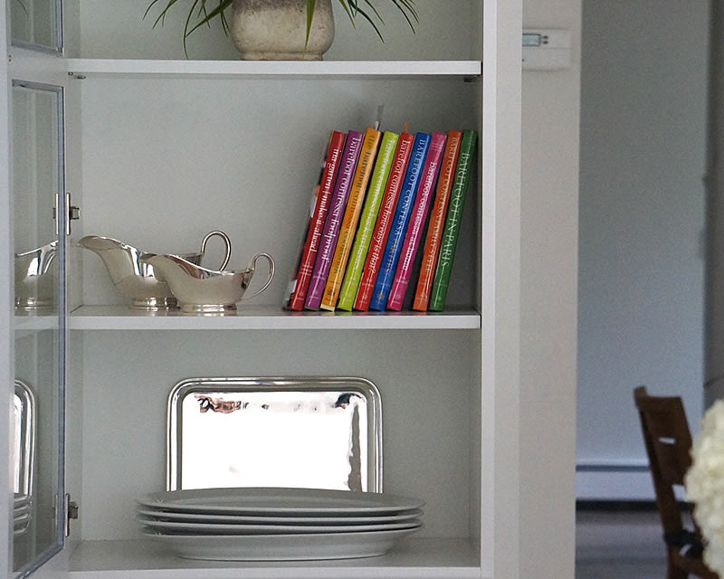 HÔTEL Silver Gravy Boats on display in kitchen cabinet next to books and dishes