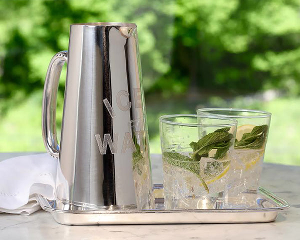 HÔTEL Silver Water Pitcher on top of a matching silver drink tray