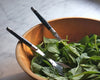 Laguiole salad serving set in wooden bowl filled with greens