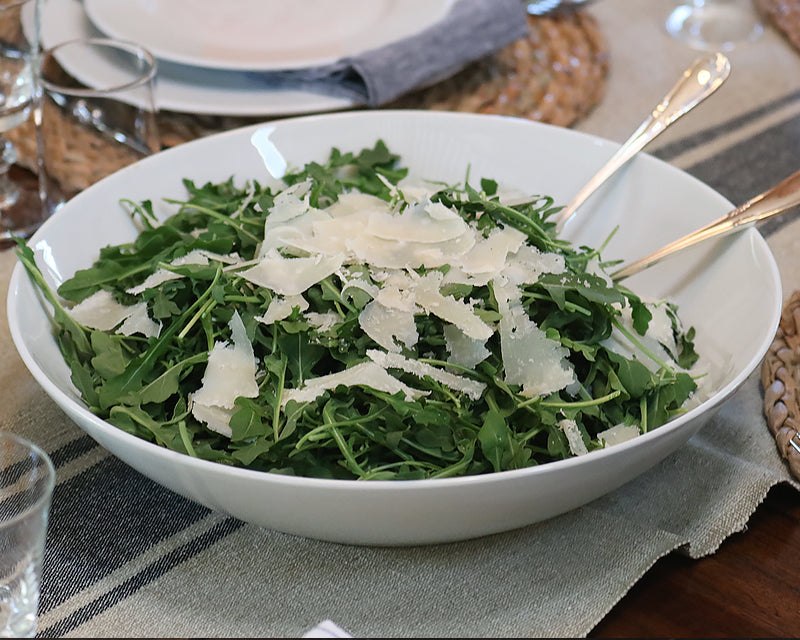 Big White Cecil Bowl filled with arugula salad and shards of fresh parmesan.