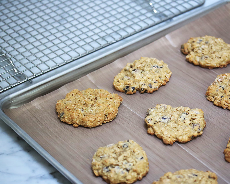 Homemade cookies on a sheet pan lined with a reusable parchment sheet