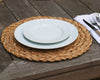 A white dinner plate and white salad plate stacked on a wicker placemat 