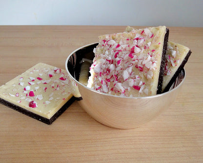 HOTEL Silver Bowl filled with peppermint bark on a wood counter top