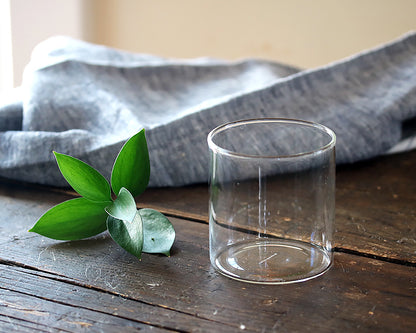 Simple Cocktail glass sitting on a dining table next to an indigo linen napkin