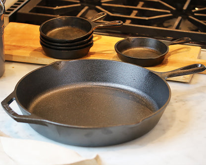 12-Inch Cast Iron Skillet on a counter top next to the mini Cast iron skillets