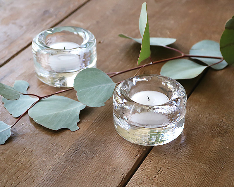 Clear glass tealight on a wood table. Adds sparkle to any table.