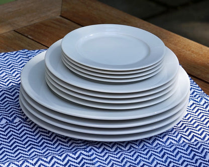 Pillivuyt dinnerplate sets stacked on a blue table cloth
