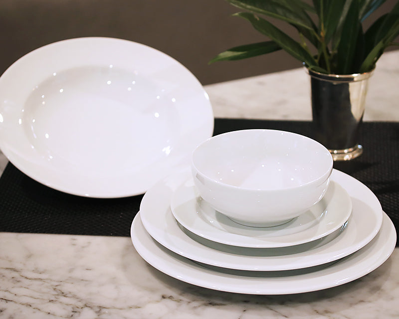 Pillivuyt dinnerware stacked including white dinner plate, salad plate, dessert plate, soup bowl, and cereal bowl